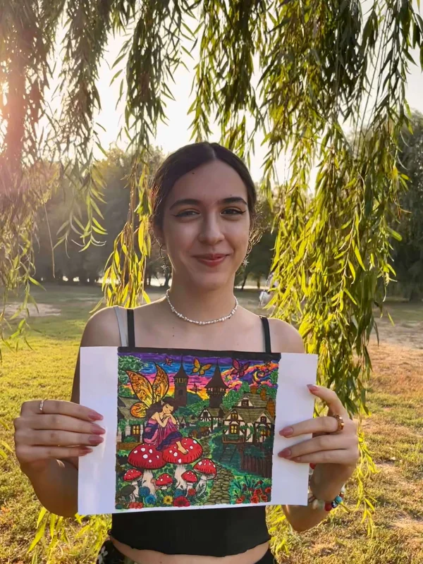 Girl holding a coloring page.